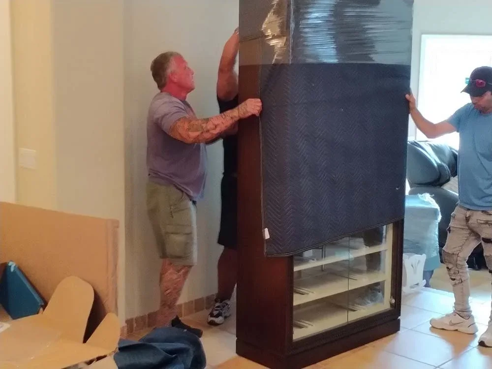 Furniture wrapped and stacked for storage inside a moving truck